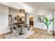 Dining area with a glass table, gray velvet chairs, and bright, natural lighting at 12469 Springmill Rd, Carmel, IN 46032