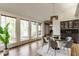 Bright dining area featuring large windows, stylish lighting, and comfortable seating perfect for Gathering meals and entertaining guests at 12469 Springmill Rd, Carmel, IN 46032