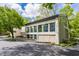 Exterior view highlighting the architectural design, large windows, and inviting entrance, complemented by the surrounding greenery at 12469 Springmill Rd, Carmel, IN 46032