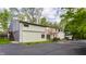 Exterior view of the home, showcasing a well-maintained facade, mature trees, and spacious driveway with ample parking at 12469 Springmill Rd, Carmel, IN 46032
