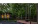Stunning modern home surrounded by lush greenery with a deck and fire pit, perfect for outdoor enjoyment at 12469 Springmill Rd, Carmel, IN 46032