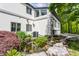Backyard exterior showcasing a serene pond with a waterfall feature, surrounded by lush greenery and a beautifully landscaped yard at 12469 Springmill Rd, Carmel, IN 46032