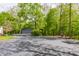 Large driveway leads to a spacious two-car garage and a charming wooden deck area at 12469 Springmill Rd, Carmel, IN 46032
