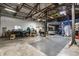 Wide-angle view of the garage interior, showcasing ample storage, workshop space, and a vehicle lift at 12469 Springmill Rd, Carmel, IN 46032
