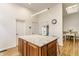 Kitchen island with granite countertop, modern cabinets, and a view to the dining area at 12469 Springmill Rd, Carmel, IN 46032
