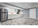 Modern kitchen featuring stainless steel appliances, white cabinets, and wood grain floors at 12469 Springmill Rd, Carmel, IN 46032