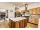 Modern kitchen with stainless steel appliances, granite countertops, a large kitchen island, and ample storage at 12469 Springmill Rd, Carmel, IN 46032
