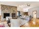 Bright and airy living room with stone fireplace, hardwood floors, and comfortable seating perfect for relaxation and entertainment at 12469 Springmill Rd, Carmel, IN 46032