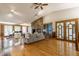 Spacious living room with hardwood floors, stone fireplace, and large windows providing ample natural light and scenic views at 12469 Springmill Rd, Carmel, IN 46032