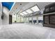 Spacious living room with skylights, large windows, built-in shelves and a striking blue accent ceiling at 12469 Springmill Rd, Carmel, IN 46032