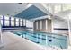 Indoor pool with staircase access to second story and ample natural light from surrounding windows at 12469 Springmill Rd, Carmel, IN 46032