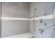 Tiled walk-in shower with a bench, handheld shower head, and window at 12469 Springmill Rd, Carmel, IN 46032