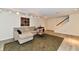 Finished basement with seating area, stairs, rug, table, and neutral colored walls at 1310 Kings Cove Ct, Indianapolis, IN 46260