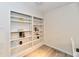 Finished basement with bookshelves and modern flooring at 1310 Kings Cove Ct, Indianapolis, IN 46260