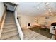 Finished basement with stairs, fireplace, shelving, modern flooring, and neutral colored walls at 1310 Kings Cove Ct, Indianapolis, IN 46260