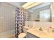 Classic bathroom featuring a shower with white and blue curtain at 1310 Kings Cove Ct, Indianapolis, IN 46260