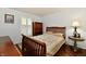 Cozy bedroom with wood floors, a wooden bed frame, and shuttered windows at 1310 Kings Cove Ct, Indianapolis, IN 46260