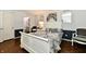 Elegant bedroom with white furniture, wood floors, and a view to the bathroom at 1310 Kings Cove Ct, Indianapolis, IN 46260