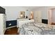 Comfortable bedroom with wood floors, a dresser, and a view into the bathroom at 1310 Kings Cove Ct, Indianapolis, IN 46260
