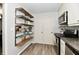 Efficient kitchen with open shelving and stainless steel appliances at 1310 Kings Cove Ct, Indianapolis, IN 46260