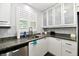 Modern kitchen showcasing granite countertops, stainless dishwasher and frosted cabinets at 1310 Kings Cove Ct, Indianapolis, IN 46260