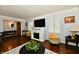 Comfortable living room with hardwood floors, a fireplace, and ample seating at 1310 Kings Cove Ct, Indianapolis, IN 46260