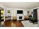 Cozy living room featuring a fireplace, hardwood floors, and elegant decor at 1310 Kings Cove Ct, Indianapolis, IN 46260
