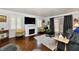 Inviting living room with a fireplace, plush seating, and natural light at 1310 Kings Cove Ct, Indianapolis, IN 46260