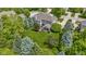 Aerial view of the home with a lush green lawn, mature trees, and a charming patio and screened-in porch at 14094 Pecos Ct, Carmel, IN 46033