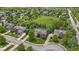 An aerial view showcasing the brick house nestled in a neighborhood with mature trees and green space at 14094 Pecos Ct, Carmel, IN 46033