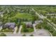 An aerial view of a home surrounded by lush greenery, mature trees, and a well-manicured lawn at 14094 Pecos Ct, Carmel, IN 46033