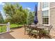 Charming back deck area featuring a metal table with an umbrella and seating with cushions, perfect for outdoor relaxation at 14094 Pecos Ct, Carmel, IN 46033