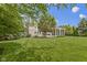 Lush backyard featuring a well-manicured lawn, patio, and screened porch, providing an ideal outdoor living space at 14094 Pecos Ct, Carmel, IN 46033