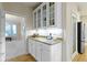 Chic bar area with granite counters, wine storage, and glass-front cabinets at 14094 Pecos Ct, Carmel, IN 46033