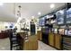 Basement bar with sink, cabinets, and a counter with barstools at 14094 Pecos Ct, Carmel, IN 46033