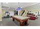 Finished basement featuring a pool table, home gym, and red leather sofas at 14094 Pecos Ct, Carmel, IN 46033
