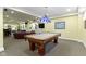 Finished basement featuring a pool table, red leather couches, and yellow walls at 14094 Pecos Ct, Carmel, IN 46033