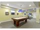Finished basement featuring a pool table, home gym, and painted yellow walls at 14094 Pecos Ct, Carmel, IN 46033