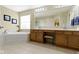Relaxing bathroom with a large soaking tub, vanity with drawers, and tile flooring at 14094 Pecos Ct, Carmel, IN 46033