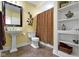 Stylish bathroom featuring a pedestal sink, rust-colored shower curtain, and built-in shelves at 14094 Pecos Ct, Carmel, IN 46033