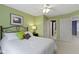 Light green bedroom with a large bed, nightstand, and doorway access to additional rooms at 14094 Pecos Ct, Carmel, IN 46033
