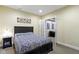 Bedroom featuring a zebra-patterned bedspread, dark wood furniture, and an ensuite bathroom at 14094 Pecos Ct, Carmel, IN 46033