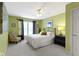 Bedroom featuring green walls, chair, window, and a large bed with decorative pillows at 14094 Pecos Ct, Carmel, IN 46033