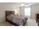 Well-lit bedroom with a ceiling fan, a wooden bed frame, bedside tables, and windows with natural light at 14094 Pecos Ct, Carmel, IN 46033