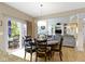 The dining area features a stylish light fixture and glass doors that lead to the backyard at 14094 Pecos Ct, Carmel, IN 46033