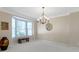 Inviting dining room with large window, chandelier, neutral colored walls and plenty of space at 14094 Pecos Ct, Carmel, IN 46033