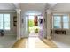 Inviting entryway boasts hardwood floors and an open door leading to a beautifully landscaped front yard at 14094 Pecos Ct, Carmel, IN 46033