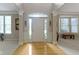 Bright entryway with hardwood floors, large window and neutral color palette offers a welcoming atmosphere at 14094 Pecos Ct, Carmel, IN 46033