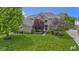 Beautiful two-story brick home featuring a lush green lawn and mature landscaping at 14094 Pecos Ct, Carmel, IN 46033