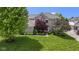 Lovely two-story home showcasing mature trees, a well-manicured lawn, and tasteful landscaping at 14094 Pecos Ct, Carmel, IN 46033